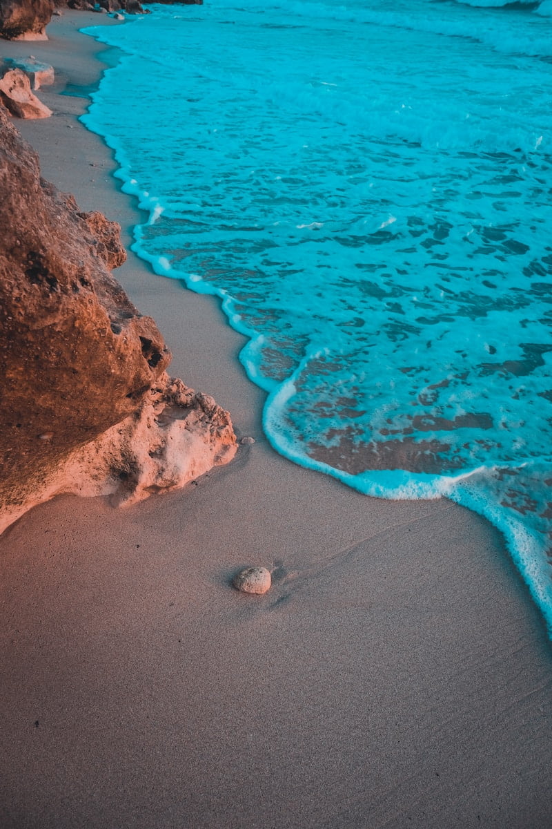 brown sand beach with brown rocks