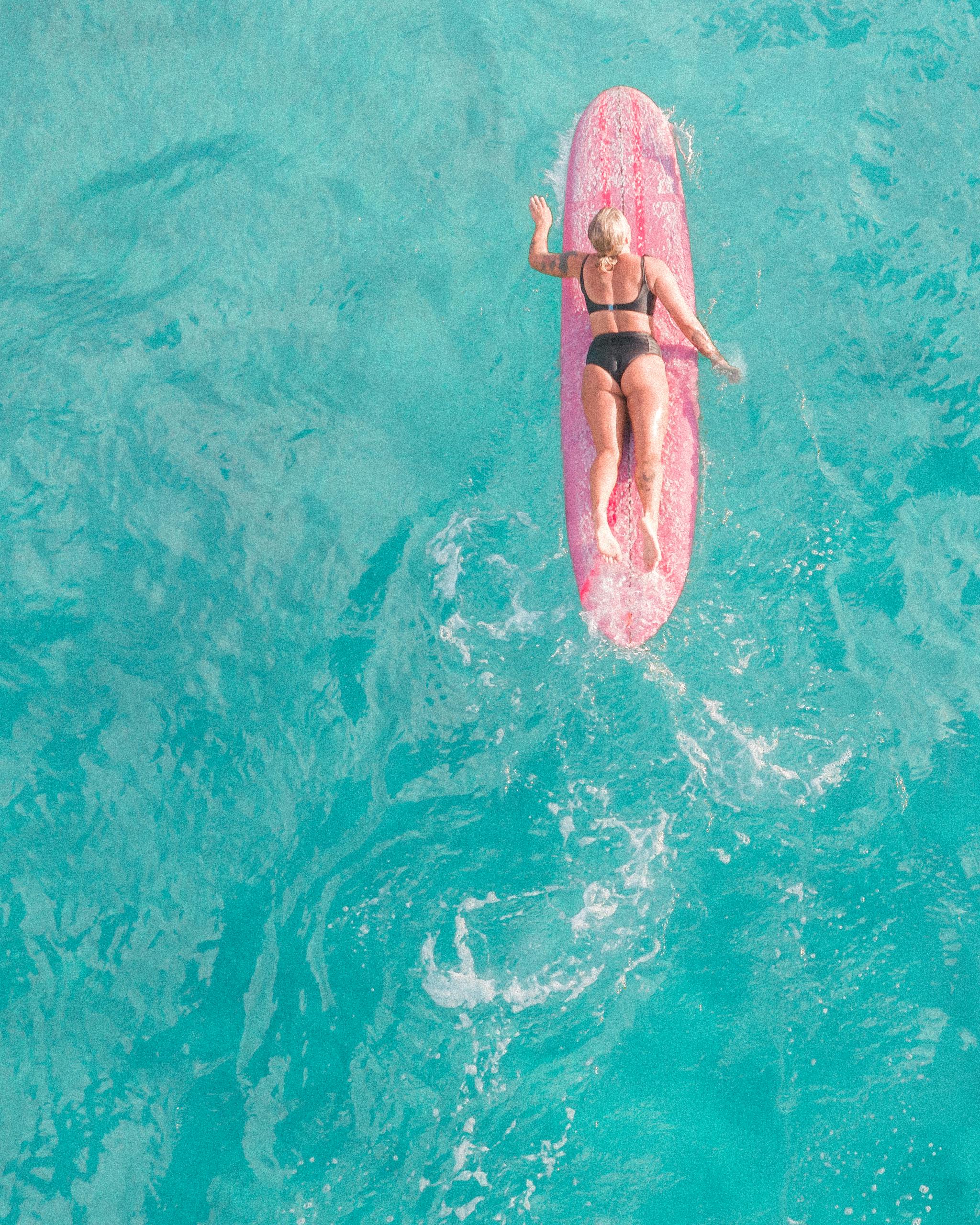 Woman in Pink Bikini Lying on Pink Inflatable Float on Water